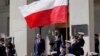 Defense Secretary Lloyd Austin, right, stands with Polish Defense Minister Mariusz Błaszczak, left, as the National Anthem is played during an arrival ceremony at the Pentagon in Washington, Apr. 20, 2022.