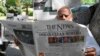 A man reads a newspaper in Islamabad on April 8, 2022, after Pakistan's Supreme Court ruled that the national assembly must reconvene to hold a no-confidence vote on Prime Minister Imran Khan.