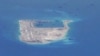 Chinese dredging vessels are purportedly seen in the waters around Fiery Cross Reef in the disputed Spratly Islands in the South China Sea in this still image taken by a P-8A Poseidon surveillance aircraft, May 21, 2015. 