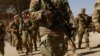 National Guard soldiers walk on the day U.S. authorities hold a ceremony to deputize the Texas National Guard to enforce Title 8 immigration laws, near the U.S.-Mexico border in El Paso, Texas, Feb. 27, 2025.