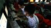 In this Sept. 27, 2012 photo, two Vietnamese students use Facebook at an internet cafe near their dormitory while they could not log in Facebook from their mobile phones because of firewall in Hanoi, Vietnam.