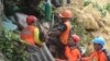 Rescuers pull out a survivor from rubble after a landslide in the city of Naga, Cebu island, Philippines, Sept. 20, 2018.