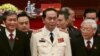 Vietnam's Public Security Minister General Tran Dai Quang (C) stands with Communist Party's General Secretary Nguyen Phu Trong (R) and Politburo member Dinh The Huynh (L) at a closing ceremony in Hanoi, January 28, 2016. 
