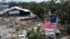 An American flag flies over the destroyed city hall in the aftermath of Hurricane Helene, in Horseshoe Beach, Florida, Sept. 28, 2024. 