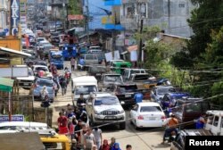 FILE - Residents who stayed at evacuation centers, because of the assault of government troops against pro-Islamic State militant groups, were allowed to return to their homes in Basak, Malutlut district in Marawi city, southern Philippines, Oct. 29, 2017.