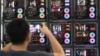 A visitor takes a picture of LED-enhanced computer motherboards during Computex 2018, at the Nangang Exhibition Center in Taipei, Taiwan, June 5, 2018.