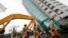 Rescuers work on a search operation at an apartment building that collapsed after a strong earthquake in Hualien County, eastern Taiwan, Feb. 7, 2018. A magnitude 6.4 earthquake struck late Tuesday night caused several buildings to cave in and tilt dangerously.