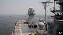 FILE - U.S. Navy sailors gather on the deck of the USS Blue Ridge as it anchors off Manila Bay west of Manila, Philippines, March 13, 2019. The ship's commander renewed an American vow to "sail, fly and operate wherever the law allows us to."