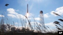  Northup Grumman's Antares rocket lifts off the launch pad at NASA's Wallops Island flight facility in Wallops Island, Va., Feb. 20, 2021. The rocket is delivering cargo to the International Space Station.